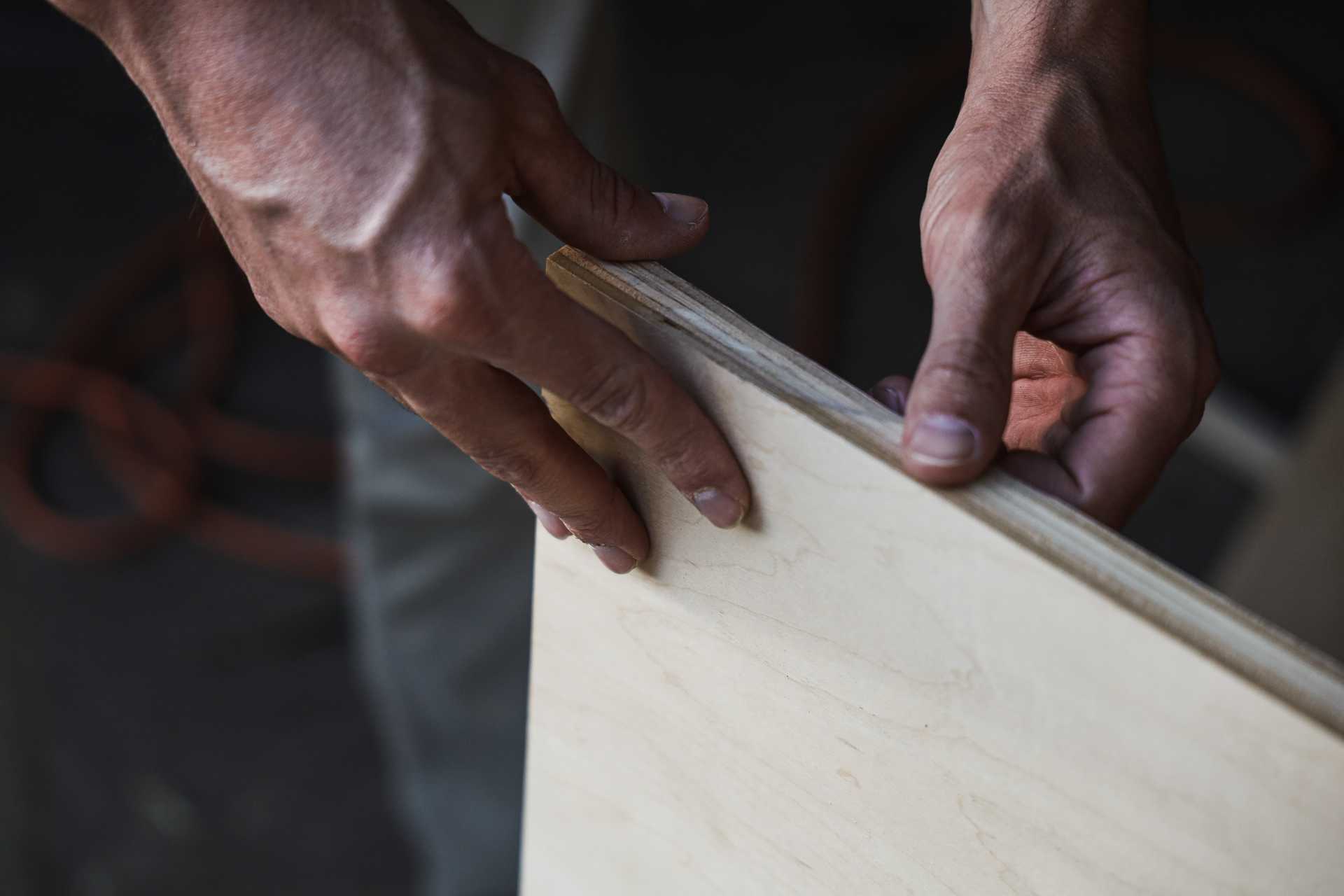 Woodworkers hands on plywood